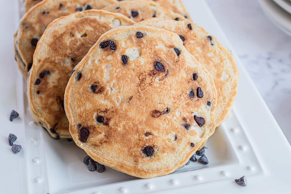 Panqueques de mantequilla de cacahuete con chips de chocolate, sobre una bandeja blanca.