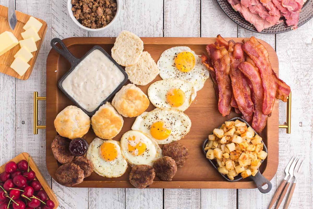 Tabla de desayuno con carne, huevos y papas.