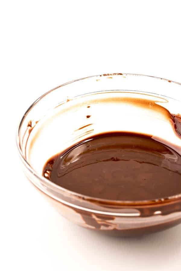 Chocolate derretido en un bol de vidrio.