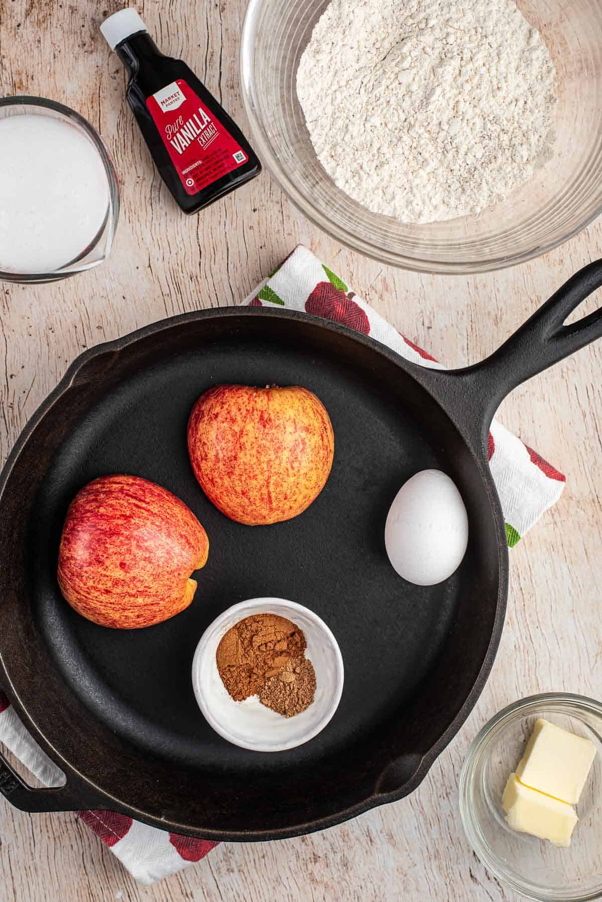 Ingredientes para panqueque de manzana y una sartén negra.